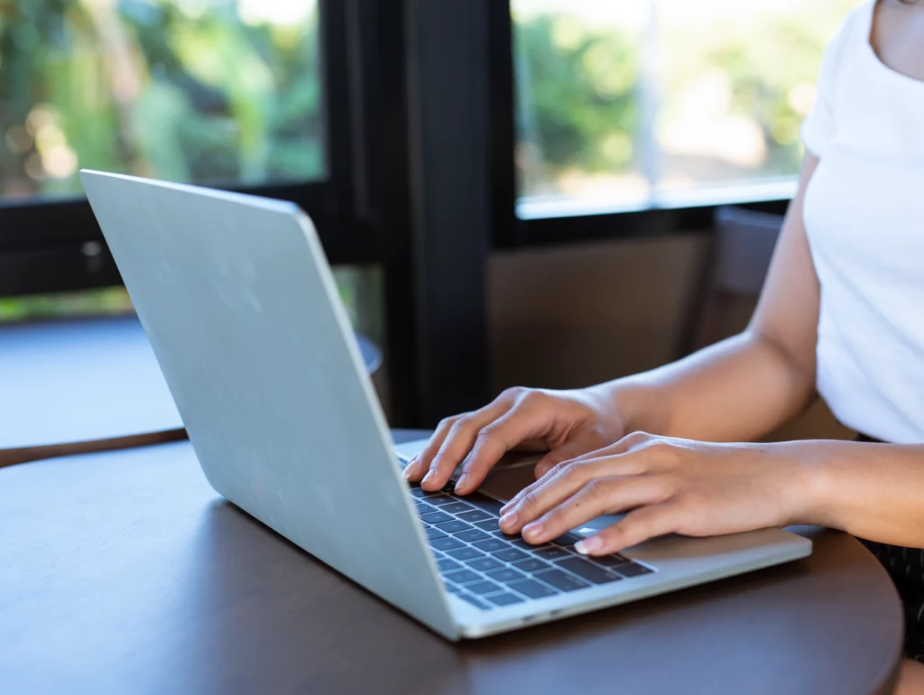 Person using iLovePDF on a computer screen.