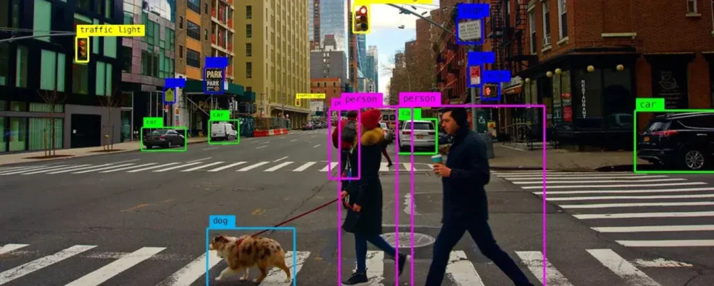 Computer vision system identifying objects and people in a city street with bounding boxes. Illustrates how AI automates recognition and analysis through Crombie’s intelligent vision-based solutions